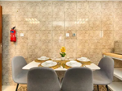 a dining room with a table and four chairs at Spacious 3BR High Floor Palm View in Dubai Marina in Dubai