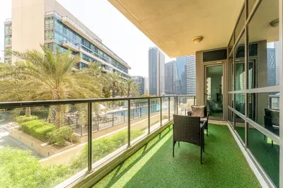 a balcony with a chair and a view of the city at HAVN - 2 Bedroom in Marina Quays, Dubai Marina in Dubai