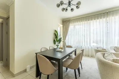 a dining room with a black table and chairs at HAVN - 2 Bedroom in Marina Quays, Dubai Marina in Dubai