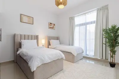 a bedroom with two beds and a window at Huge Sky Villa With Panoramic Golf Views in Dubai
