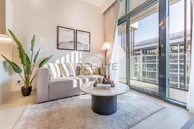 a living room with a couch and a table at Pool Views 1BR Close to Major Landmarks in Azizi Riviera 18, Al Merkadh by Deluxe Holiday Homes in Dubai