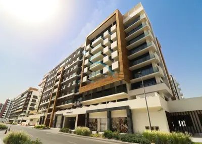 a large apartment building on the side of a street at Pool Views 1BR Close to Major Landmarks in Azizi Riviera 18, Al Merkadh by Deluxe Holiday Homes in Dubai