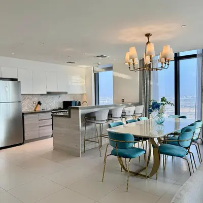 a kitchen and dining room with a table and chairs at THE COVE Creek Harbour in Dubai