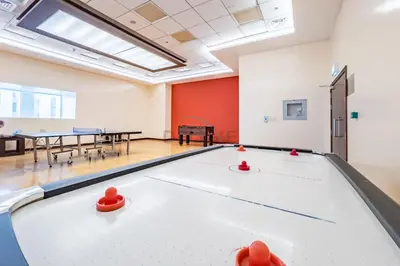 a pool table in a room with ping pong balls at Upgraded 1BR Overlooking Palm Jumeirah & Sea Views from Living to Bedroom, Elite Residence, Dubai Marina by Deluxe Holiday Homes in Dubai