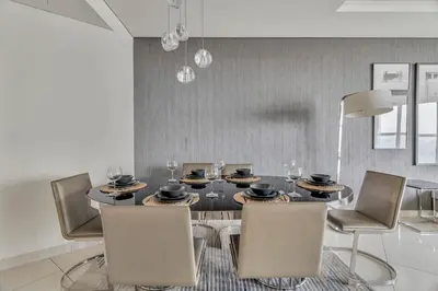 a dining room with a black table and chairs at GuestReady - Luxurious interiors in Business Bay in Dubai