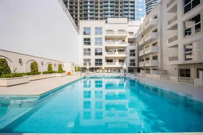 a swimming pool in the middle of a building at Livbnb-Modern 1BR Oasis with Stunning Terrace, JVC in Dubai