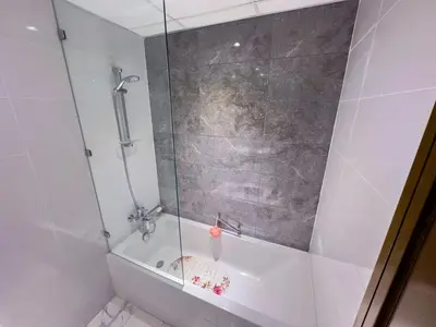 a shower with a glass door in a bathroom at Luxury Meets Serenity 2BR Apt in Noura Tower in Dubai