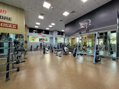 a gym with several people exercising in a gym at Luxury Meets Serenity 2BR Apt in Noura Tower in Dubai