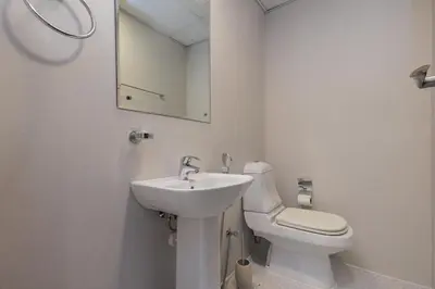 a white bathroom with a sink and a toilet at Waterfront flat Stunning view Sleeps 6 in Dubai