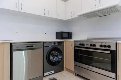 a kitchen with a dishwasher and a washer at Waterfront flat Stunning view Sleeps 6 in Dubai