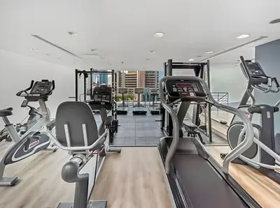 a gym with treadmills and elliptical machines at 1BR Botanica Dubai Marina in Dubai