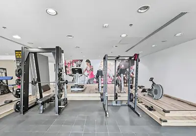 a gym with rows of treadmills and machines at 1BR Botanica Dubai Marina in Dubai