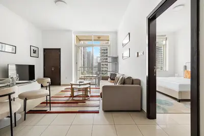 a living room with a couch and a bed at 1BR Botanica Dubai Marina in Dubai