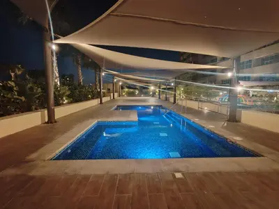 a swimming pool in a building at night at Stunning Studio at JVC Damac Ghalia - Msgetaways in Dubai