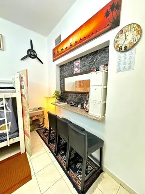 a dining room with a table and two chairs at Bed in mixed room in Dubai