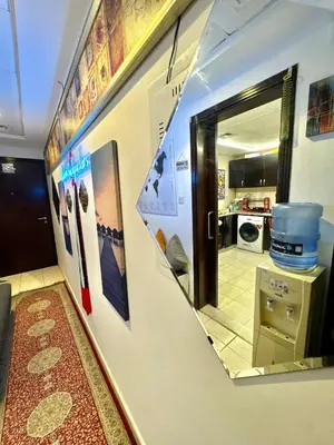 a mirror on a wall in a room with a kitchen at Bed in mixed room in Dubai