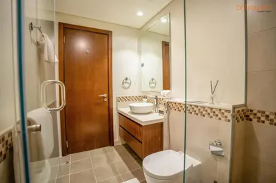 a bathroom with a toilet and a sink and a shower at Cozy Retreat with Burj Views by Bnbeyond in Dubai