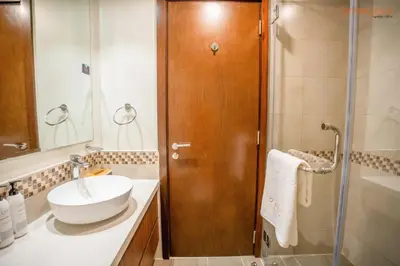 a bathroom with a sink and a shower at Cozy Retreat with Burj Views by Bnbeyond in Dubai