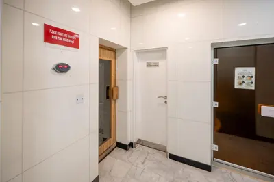 a hallway with a door and a sign on a wall at 160M2 Modern 2-bedrooms apartment with fantastic views in Dubai