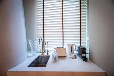a kitchen counter with a sink and a window at 160M2 Modern 2-bedrooms apartment with fantastic views in Dubai