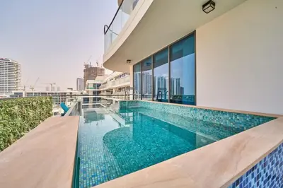 a swimming pool on the roof of a building at FAM Living - Samana Park Views - Brandnew 1Bed in Dubai