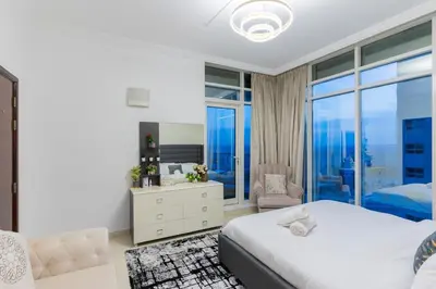 a bedroom with a bed and a large window at New Elegant & Luxury 3BR Apartment In Dubai Marina in Dubai