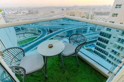 a balcony with a table and chairs on a building at New Elegant & Luxury 3BR Apartment In Dubai Marina in Dubai