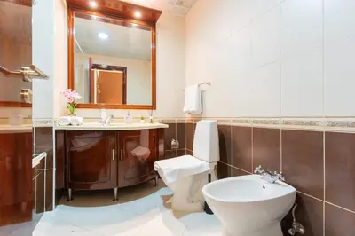 a bathroom with a toilet and a sink and a mirror at New Elegant & Luxury 3BR Apartment In Dubai Marina in Dubai