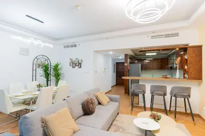 a living room with a couch and a table at New Elegant & Luxury 3BR Apartment In Dubai Marina in Dubai