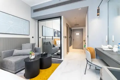 a living room with a couch and a table at Vogue Downtown Mag 318 near Burj Khalifa and Dubai Mall, Studio Apartment with Balcony, Canal and City View, Access to all Amenities in Dubai