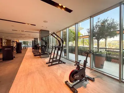 a gym with treadmills and ellipticals in a building at Frank Porter - Grande Signature Residences in Dubai