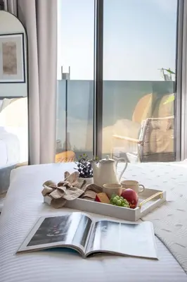a tray of food on a table with a book at Frank Porter - Aykon City Tower C in Dubai