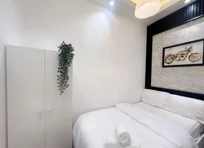 a bedroom with a bed with a picture of a motorcycle on the wall at Attraction Partition Room in Barsha heights Tecom in Dubai