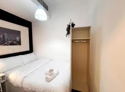 a bedroom with a bed with a towel on it at Center Point Partition Room in Tecom in Dubai