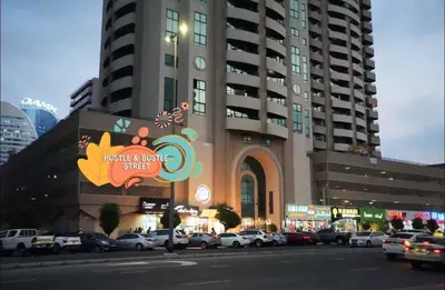 a large building with cars parked in a parking lot at Center Point Partition Room in Tecom in Dubai