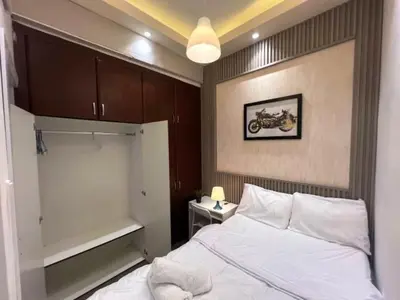a bedroom with a bed and a motorcycle on the wall at Network Partition Room Near Internet City Metro in Dubai