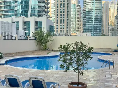 a swimming pool in a city with tall buildings at Perfect Marina Stay - Ideal for great Holidays in Dubai