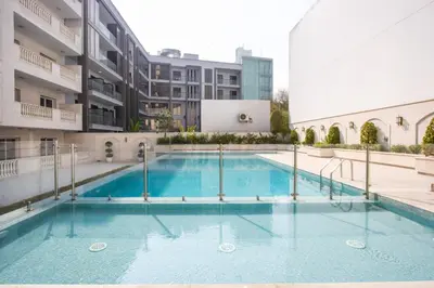 a swimming pool in the middle of a building at Livbnb - Homey 1B with Spacious Terrace in District 14, JVC in Dubai