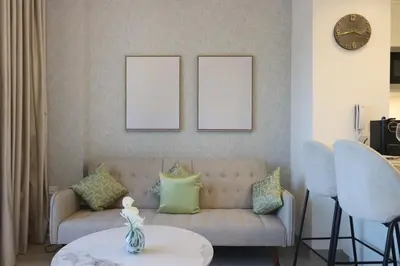 a living room with a couch and a table at Livbnb - Homey 1B with Spacious Terrace in District 14, JVC in Dubai