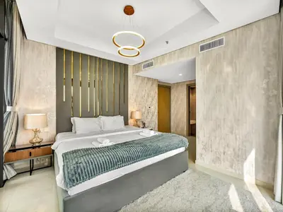 a bedroom with a large bed in a room at Lux Apartments in BusinessBay, Canal views, Great Location in Dubai