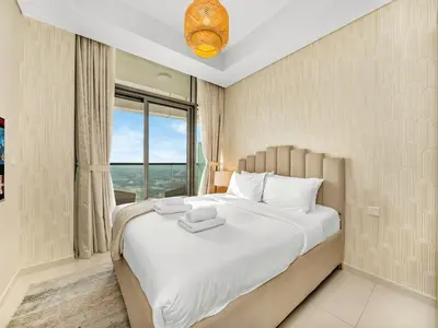 a bedroom with a large bed with a window at Lux Apartments in BusinessBay, Canal views, Great Location in Dubai
