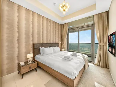a bedroom with a large bed and a large window at Lux Apartments in BusinessBay, Canal views, Great Location in Dubai