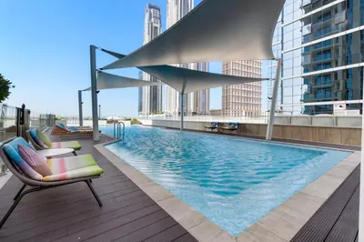 a swimming pool on the roof of a building at LUX 2BR in Missoni Tower - 5 mins to Burj Khalifa in Dubai