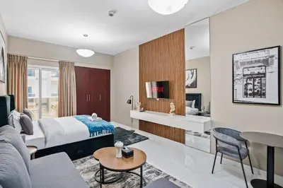 a hotel room with a bed and a living room at Newly Built Studio - Urban Living in Dubai
