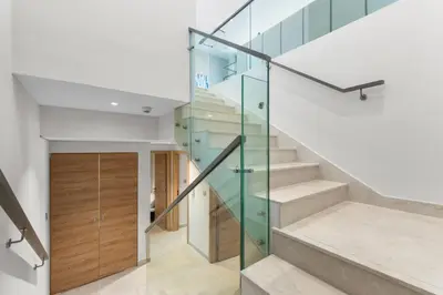 a glass staircase in a house at NEW! Spacious 2BHK with Maids room - JVC in Dubai