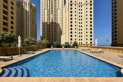 a large swimming pool in a city with tall buildings at Bahar 6 in Dubai