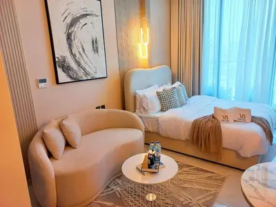 a living room with a couch and a bed at Arjan Bright Studio w Resort Amenities Samana PV by Vibel in Dubai