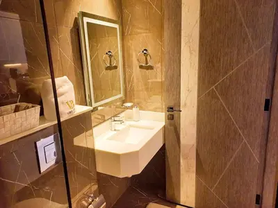 a bathroom with a sink and a shower with a mirror at Arjan Bright Studio w Resort Amenities Samana PV by Vibel in Dubai