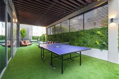 a ping pong table in the middle of a courtyard at Next'Living - Luxury Private Room in a Shared Villa in Dubai