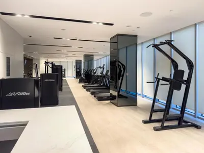 a row of treadmills in a gym with exercise equipment at 1 Bedroom apt High end luxurios building Next to Dubai mall in Dubai